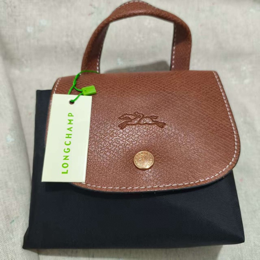 Longchamp Black Canvas Backpack With Gold Buckle And Brown Flap